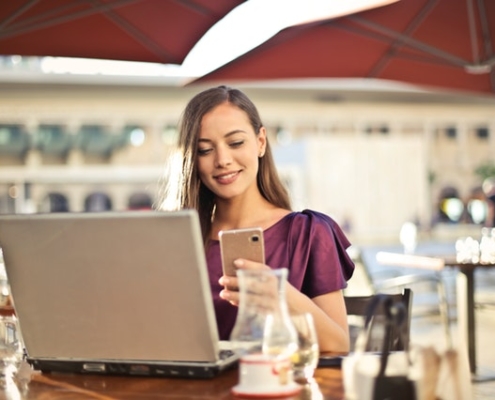 woman using mobile phone and desktop to search for products