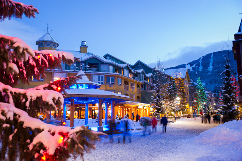 Whistler Village in winter with snow and christmas lights